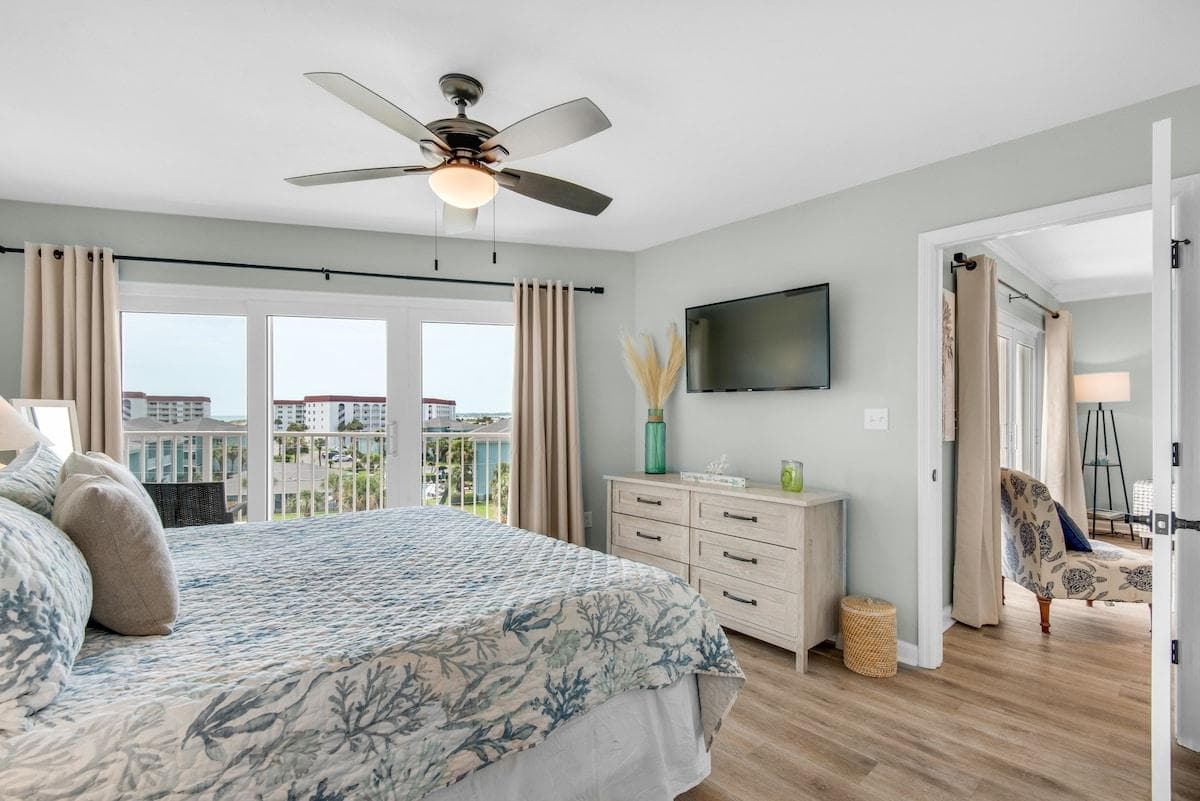 King Bedroom with Balcony Access and outdoor private seating chairs and table